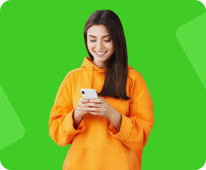 A young woman in a yellow sweater looking at her smart phone